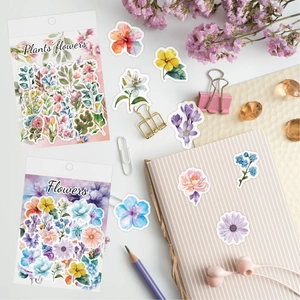 Flat lay of vintage butterfly flower stickers with watercolor floral washi paper details