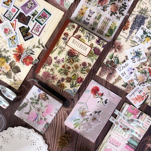 Vintage floral scrapbooking set with aesthetic notebooks and stickers on wood