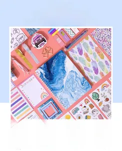 Flat lay of DIY journal set with marble notebooks, stickers, and planner stationery