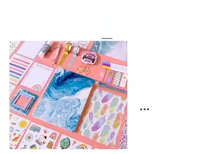 Flat lay of pink DIY journal set with marble notebook, stickers, and planner stationery