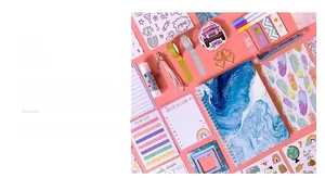 Flat lay of DIY journal set with blue marble notebook, stickers and colorful stationery