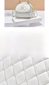 Detailed view of white quilted stitching pattern and gold zipper on a chic shell bag