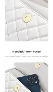 Close-up of white quilted leather bag with front pocket and magnetic closure details