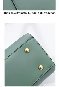 Detail of green lychee leather handbag base with gold studs and precise stitching