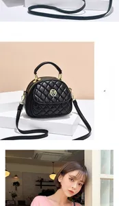 Detailed view of black quilted leather handbag with gold M logo and adjustable strap