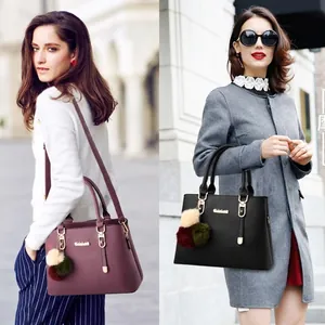 Elegant purple and black textured leather tote bags with plush charm for women