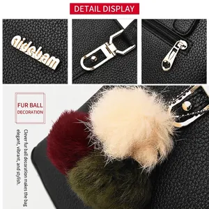 Black pebbled leather tote bag for women with gold hardware and colorful pom-pom charm