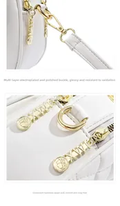 Detail of white quilted leather bag showing gold hardware and logo zipper puller