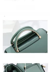 Detail of Morandi green leather handbag featuring semi-circular metal handles and fine stitching