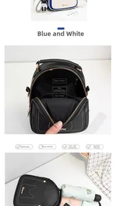 Detail view of the multi-compartment interior and kitten embroidery on compact backpacks