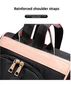 Detail of reinforced black straps and pink leather crossbar on oxford backpack