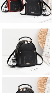 Detail of mini leather backpack with cat ear stitching and cute bear charm accessory