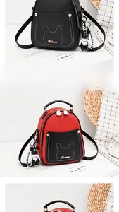 Detail of cross-grain PU leather backpack with cat ear stitching and bear charm
