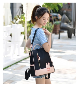 Detail of oxford backpack for women with bunny ears design and pink leather trim accents