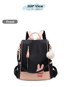 Front view of black and pink oxford backpack with rabbit ears and plush pompom pendant