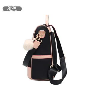Side view of oxford cloth backpack with pink trim and white plush ball charm