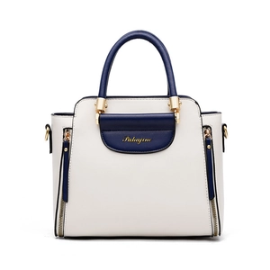 Minimalist white and blue contrast tote bag with gold hardware and top handle