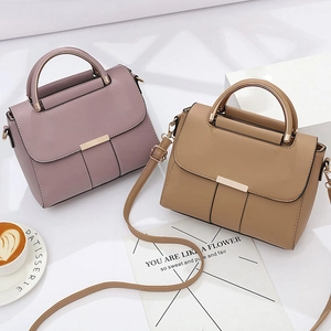Minimalist leather handbags in pink and brown with elegant metallic round handles
