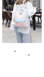 Detail of tricolor macaron backpack featuring pastel pink flap and fluffy white pompom charm