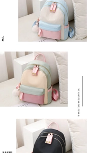 Detail view of colorful nylon backpacks featuring dual zippers and decorative pendants