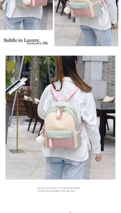Detailed views of a tricolor nylon backpack featuring a plush ball charm and gold zippers