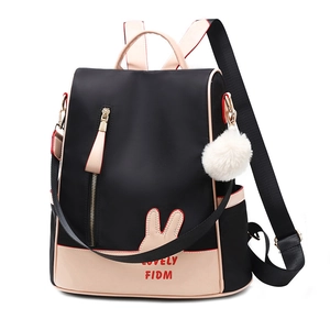 Chic oxford cloth backpack in black and beige with a fluffy ball charm and bunny ears