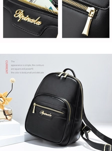 Detailed view of the gold zipper and Pipirala logo on a black pebbled leather backpack