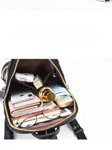 Top view of the spacious black faux leather backpack interior showing daily essentials