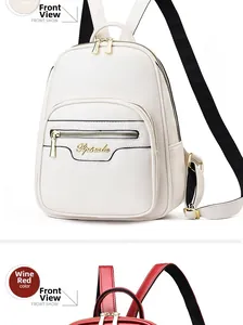 Detail view of white and wine red PU leather backpacks with adjustable straps and front zip