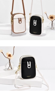 Detail of mini crossbody phone bags in contrast colors with dual zipper and magnetic buckle