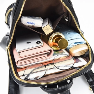 Large capacity black faux leather backpack interior showing storage space for tablets