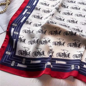 Close-up of carriage print silk scarf with luxury horse pattern and belt border details