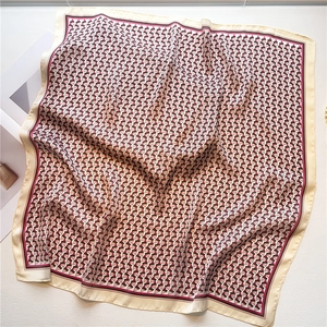 Detail of soft silk-like fabric with geometric patterns and elegant warm color blocks