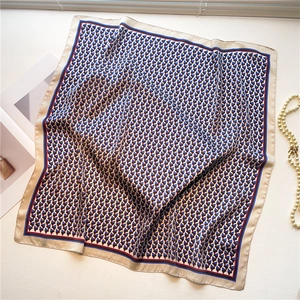 Detail of geometric pyramid patterns and champagne borders on a silk square scarf