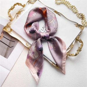 Carré de soie violet motif pissenlit avec bordure en satin rose sur plateau doré