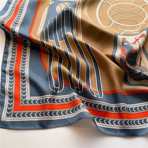 Detailed view of luxury silk scarf with elegant chain floral prints and smooth texture