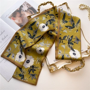 Elegant mustard yellow floral skinny silk scarf with butterflies on vintage tray