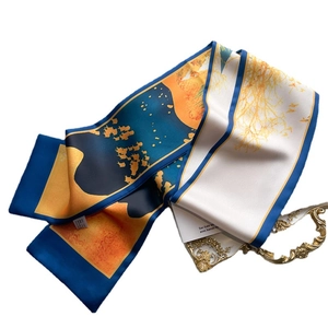 Artistic long silk scarf with blue and orange silhouette patterns on white background
