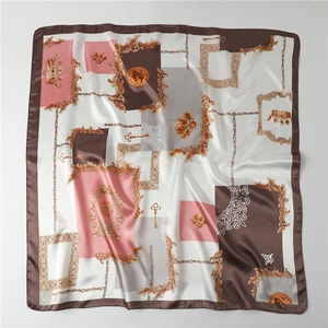Detail of baroque silk-satin scarf showing gold patterns and elegant fabric texture