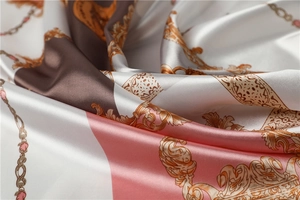 Detailed view of 90x90cm satin silk scarf with baroque gold patterns and chain prints