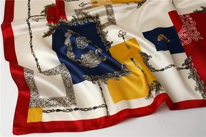 Detailed close-up of a 90x90cm silk scarf with vintage Baroque key and chain prints