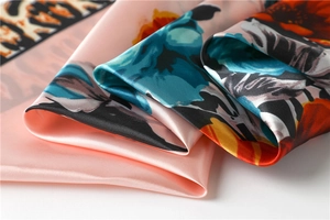 Detailed close-up of glossy satin scarf featuring floral patterns and leopard print details