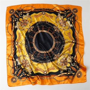 Detailed shot of 90cm satin scarf featuring orange and gold equestrian chain patterns