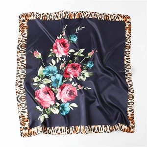 Detailed texture of satin square scarf with floral roses and leopard print border