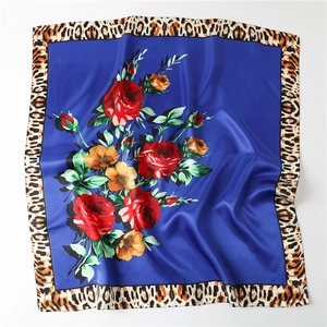 Detail view of satin scarf with red floral pattern and leopard print border