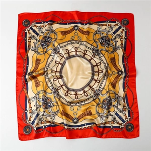 Detailed close-up of retro chain print on smooth red and gold satin square scarf