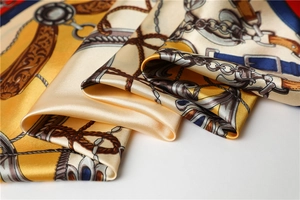 Detailed close-up of premium satin scarf featuring vintage chain and buckle prints