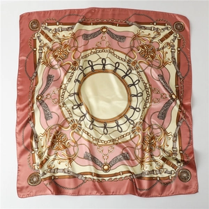Detail view of square satin scarf with baroque equestrian gold chains and floral patterns