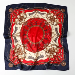 Detail of satin square scarf featuring vintage metal chain and leather strap patterns