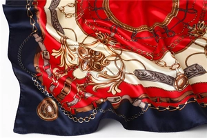 Detail of silk-like satin scarf featuring equestrian chains and baroque patterns